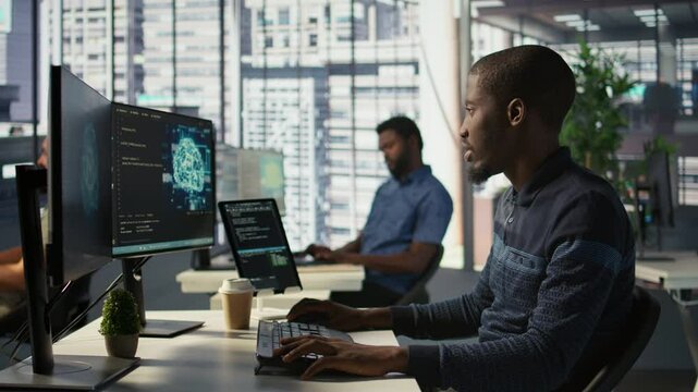 Admin creating AI machine learning models that can process and analyze data to improve decision making processes, looking at PC. Man programming in office using artificial intelligence tech, camera B