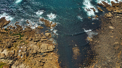 Aerial View of Rocky Coastline and Ocean Waves in Cornwall, UK