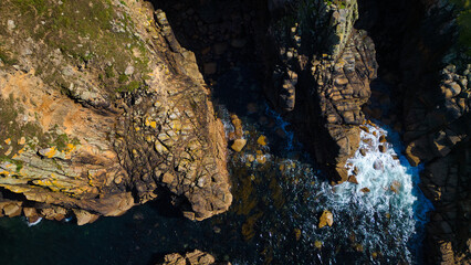 Aerial View of Rocky Coastline with Waves at Land's End, Cornwall, UK