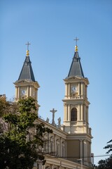 Fototapeta premium Two clock towers of Katedrala Bozskeho Spasitele cathedral in Ostrava, Czechia