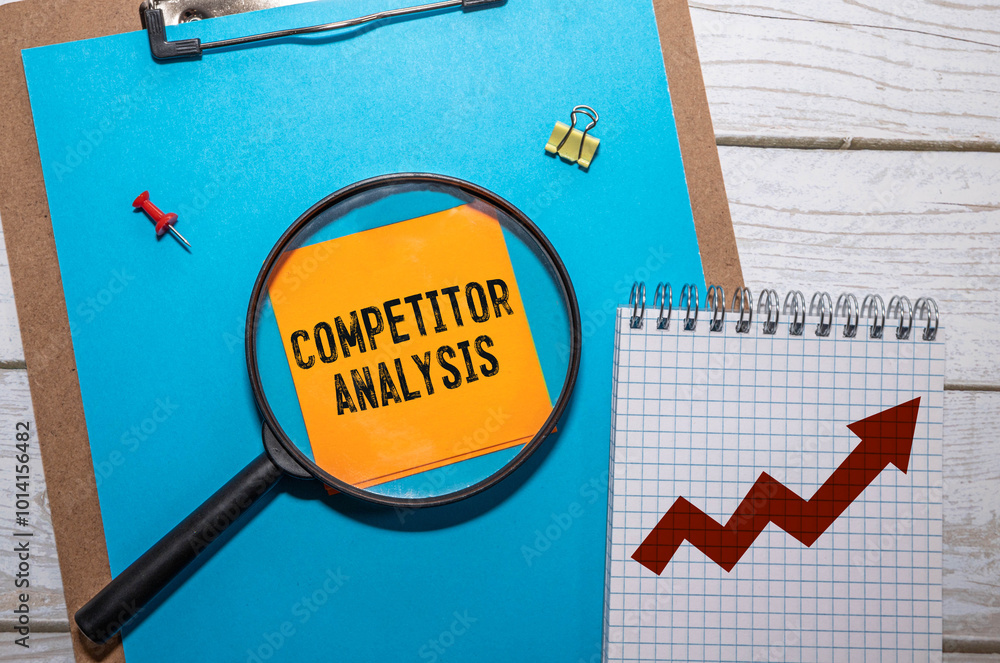 Poster competitor analysis text on sticky on red notebook