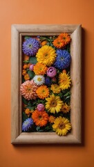 Colorful bouquet of daisies and flowers in wooden square frame, vibrant orange background.