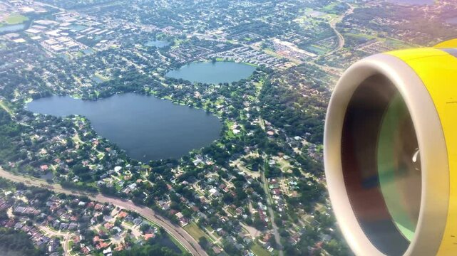 large airline jet engine over residential properties from a passenger airliner over orlando florida
