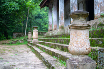 Naklejka premium Ancient stone pillars outside weathered temple steps