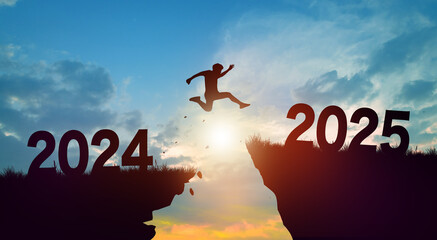 Welcome merry Christmas and Happy new year in 2025. Man jumping across the gap from 2024 to 2025 cliff with Sunset and Twilight Sky background.