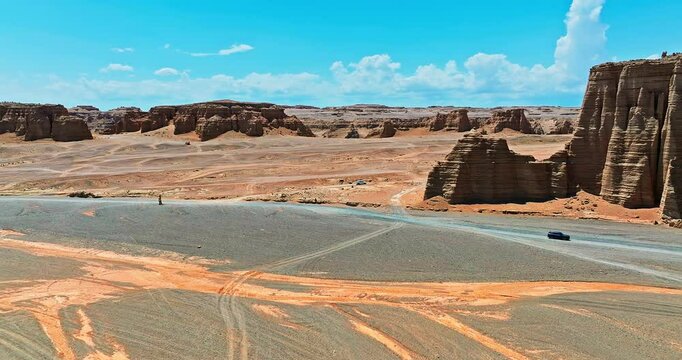 Spectacular Dahaidao Yardan landform natural landscape in Xinjiang, China. Driving a car through the desert Gobi in no man's land.