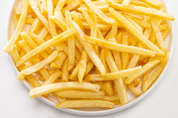 close up of French fries on a plate.
