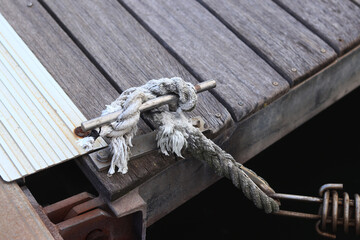 Mooring post, a mooring knot on a yacht pier. The yacht's mooring ropes are attached to the knecht. Knecht on the deck on the pier for fastening ropes. Knecht for mooring and fastening ropes