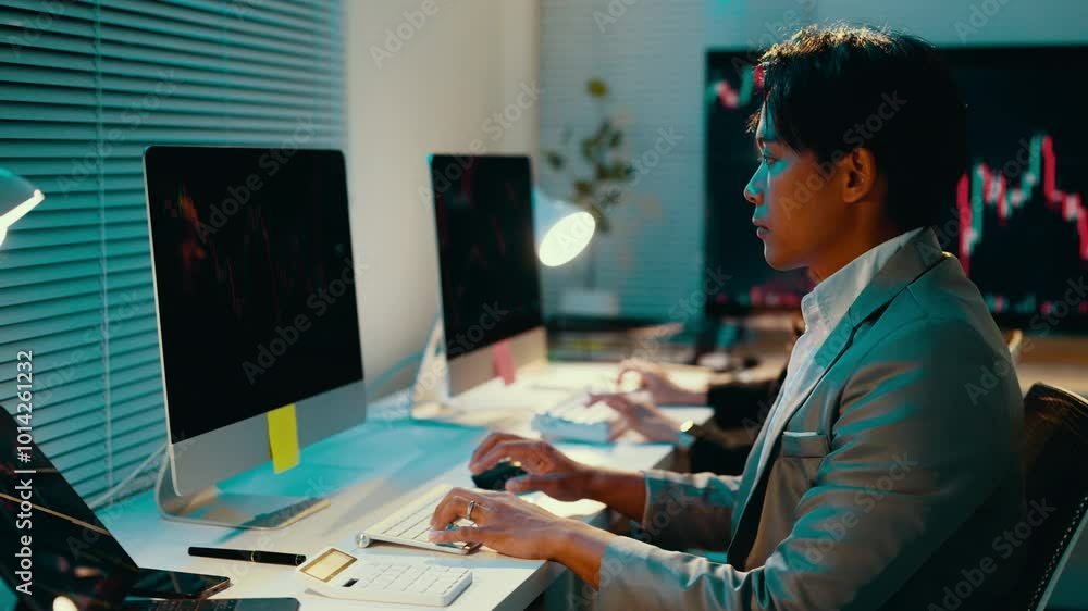 Poster businessman is working late in the office. he is intensely typing on his keyboard in the dark with t