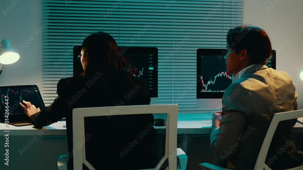 Poster business professionals working late at night in an office, analyzing financial data and charts displ