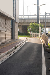 Concrete structure and asphalt road space under the overpass in the city