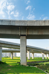 Obraz premium Concrete structure and asphalt road space under the overpass in the city