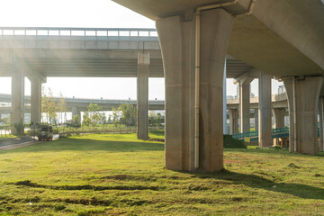 Concrete structure and asphalt road space under the overpass in the city