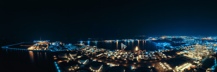 Naklejka premium Aerial Industrial city view of white oil tank storage chemical petroleum petrochemical refinery product at oil terminal. Oil terminal storage tank in deep seaport for the international order concept.