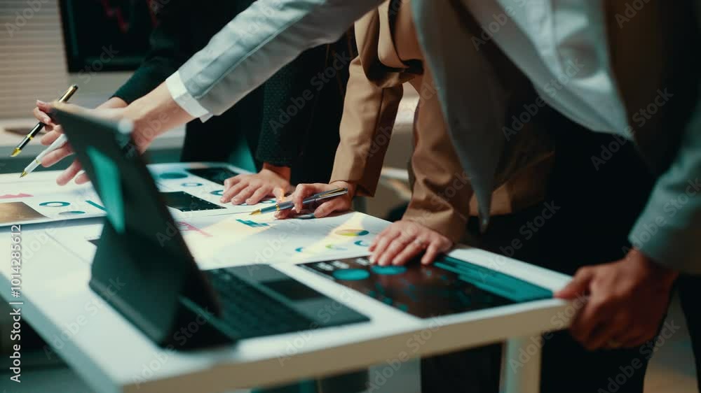 Poster Businesspeople in a meeting room are pointing at documents and using interactive touchscreen to analyze financial data displayed on it