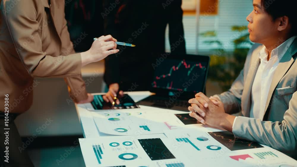 Aufkleber businesswoman pointing at charts and graphs during a meeting with colleagues. the discussion focuses