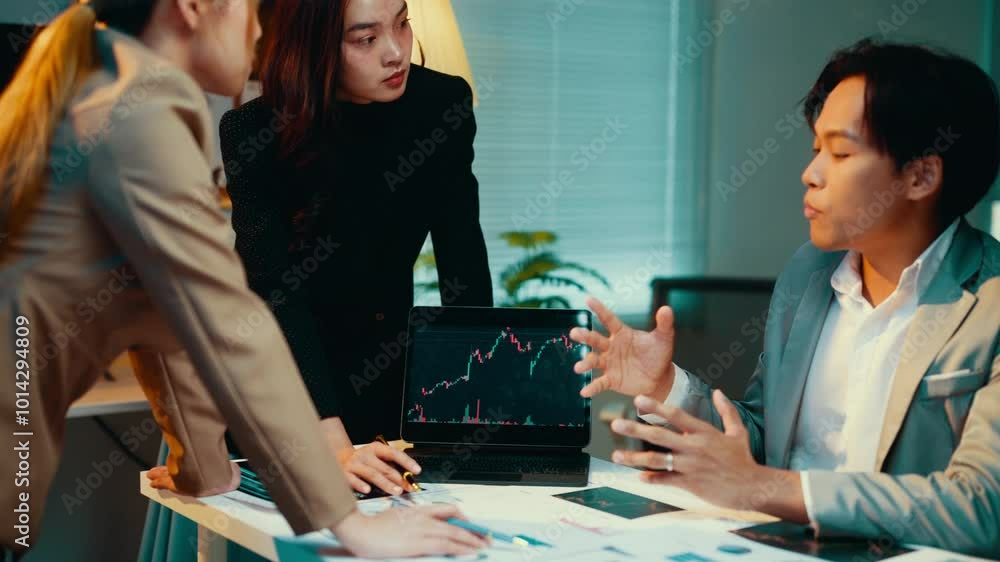 Poster business teams engage in discussions about stock market data displayed on a laptop screen, analyzing