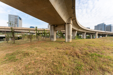Concrete structure and asphalt road space under the overpass in the city