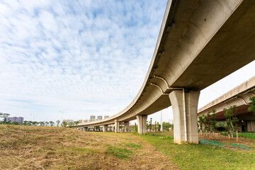 Concrete structure and asphalt road space under the overpass in the city
