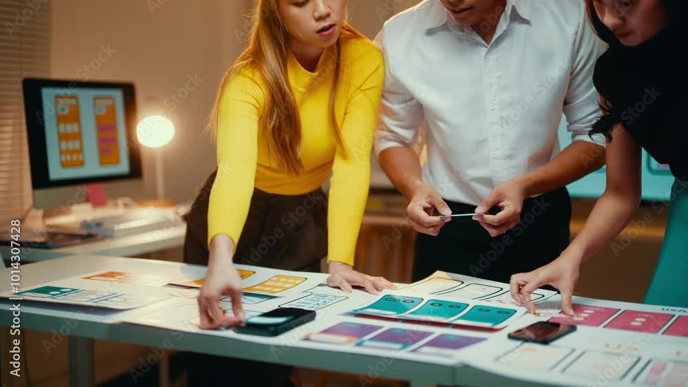 Aufkleber Three asian ui/ux designers are working together on a new mobile application. They are using paper prototypes to test different design ideas