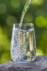 drinking water pouring into glass on stone