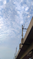 Fototapeta premium View of clear blue sky from below with buildings
