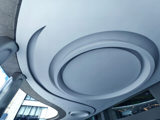 A modern ceiling that features a circular design