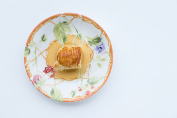 Pineapple tart cookies also known as Nastar served in a ceramic plate, isolated on white background.