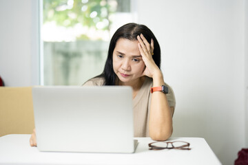 a businesswoman who is overworked, migraine-weary, and anxious about a deadline. Concerns about professional, employee, and mental health in connection to anxiety, burnout, and project fatigue