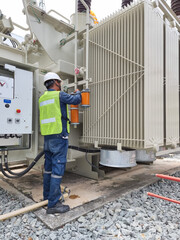 Vertical shot of Orange Silica Gel replacement activity by electrician for Silica Gel Breather at...