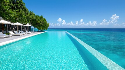 Luxurious infinity pool overlooking turquoise ocean under a clear blue sky, perfect vacation getaway.