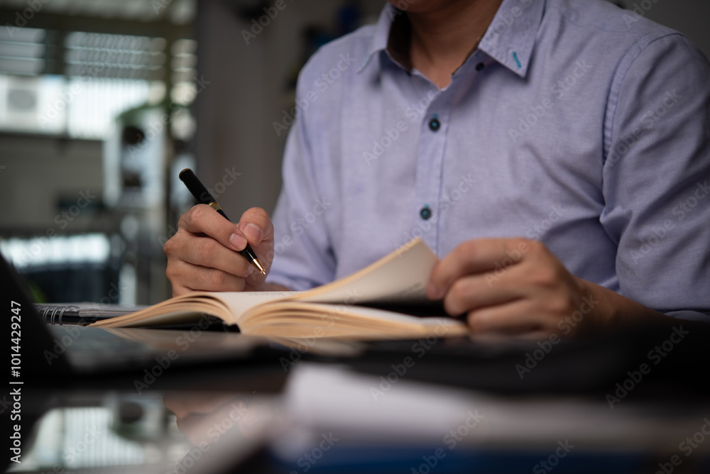 Poster businessman writing notes in a notebook, planning tasks with focus and organization. ideal for busin