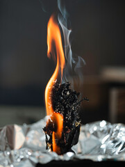 Black candle with herbs, wormwood, St. John's wort., tools for ritual concept photo. Dark witch...