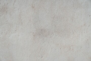 Textured Plaster Wall Background. A close-up of a textured plaster wall with an abstract rough surface. The neutral light beige color and irregular patterns create a natural and artistic backdrop. 