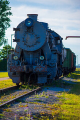 Historic Steam Locomotive on Display at a Train Station