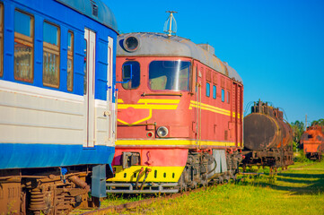 Obraz premium A display of historic Estonian railway rolling stock, featuring diesel locomotives and passenger carriages in Haapsalu.