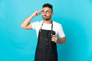 Barber man in an apron having doubts and thinking