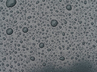 Water Droplets on a Smooth Surface with Light Reflections Creating an Abstract Pattern