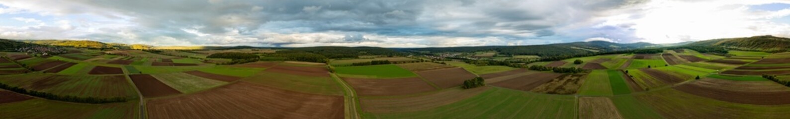 360 panorama, aerial view, drone photography, unterfranken, rhön, landscape, weather, rain, fields, hills, countryside, scenic view, nature, rolling hills, agriculture, expansive, rural, vibrant color