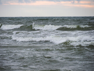 The Fiery Dance of Waves Under a Stormy Sky on the Boundless Sea