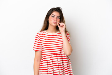 Young caucasian woman isolated on white background showing a sign of silence gesture