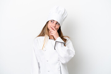 Young caucasian chef woman isolated on white background having doubts and with confuse face expression