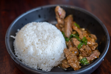 Rice with Kaprao beef served on plate. It is Thai style stir-fried holy basil with meat.