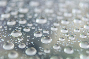 Side angle of clear raindrops on a transparent surface. Rain reflections theme