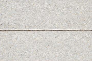 A piece of gray recycled cardboard folded in two parts for your design, lettering concept