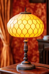 Elegant vintage lamp with a honeycomb shade on a wooden surface.