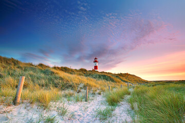 lighthouse on the island Sylt near the sea in sunrise light