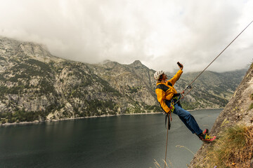A man is taking a selfie while rock climbing