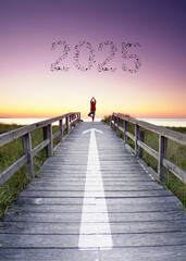 woman in yoga pose on the pier over the ocean with flying birds in shape of 2025