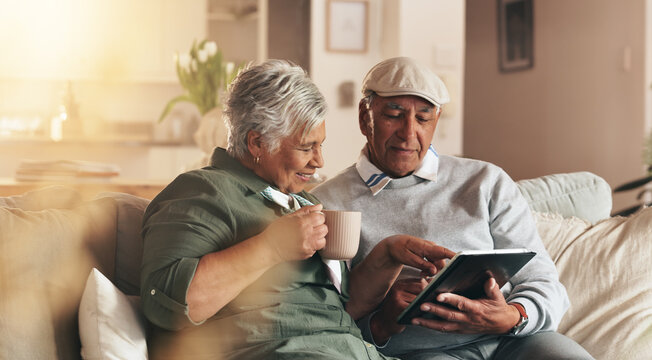 Retirement, old couple and smile for tablet, coffee and browsing for news, watch and bonding in morning. House, digital and senior people with app, subscription and relax in living room and happy
